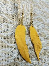 Mustard dangling feather earrings