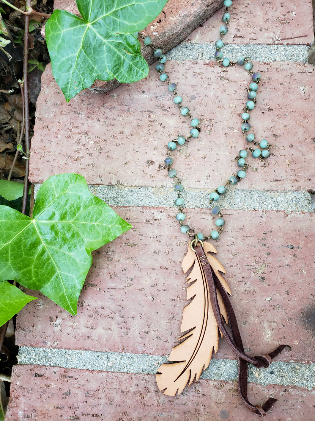 Green beaded feather necklace