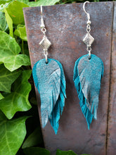 Metallic teal feather earrings